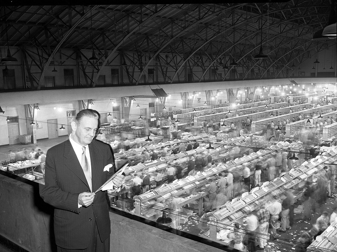 Workers sorting mail into groups