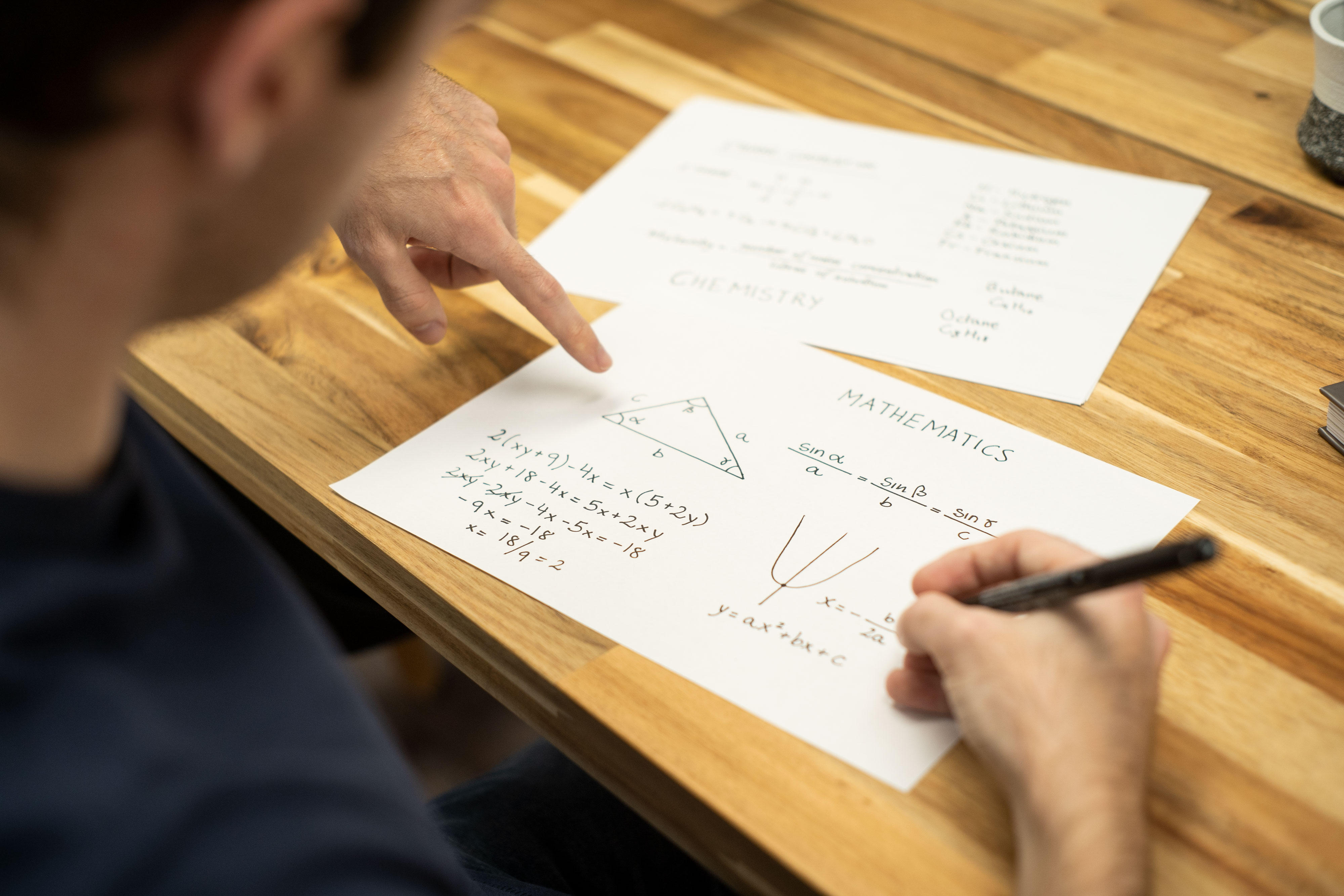 A tutor checking a student’s homework